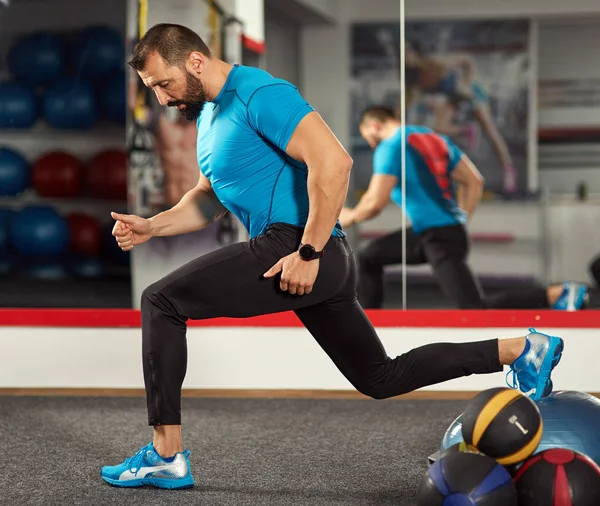 Trainer working with balance ball in gym