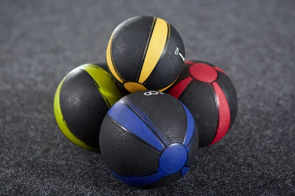 Colorful medicine balls on gym floor