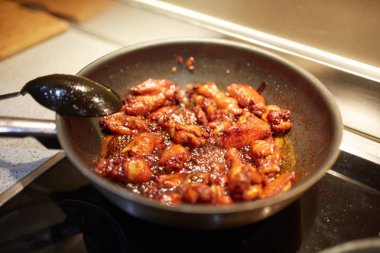 Tay tarifi için caramelizing tavuk kanadı ile Wok tava