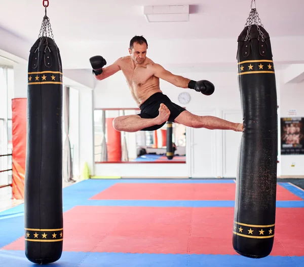 ジムで重いかばんとトレーニング Kickbox 戦闘機 — ストック写真