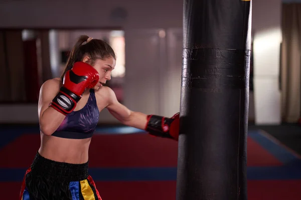 Young Woman Boxer Training Heavy Bag — 图库照片