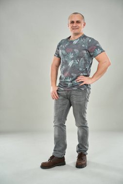 Portrait of a caucasian man on gray background, full body