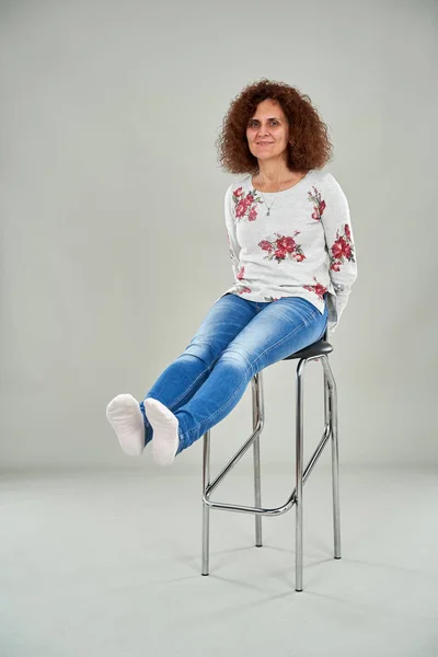 Happy Curly Redhead Woman Sitting Tall Chair Studio Shot — Stok fotoğraf