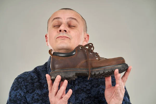 Man Holding Shoe Which Appears Smelling Pleasant — 스톡 사진