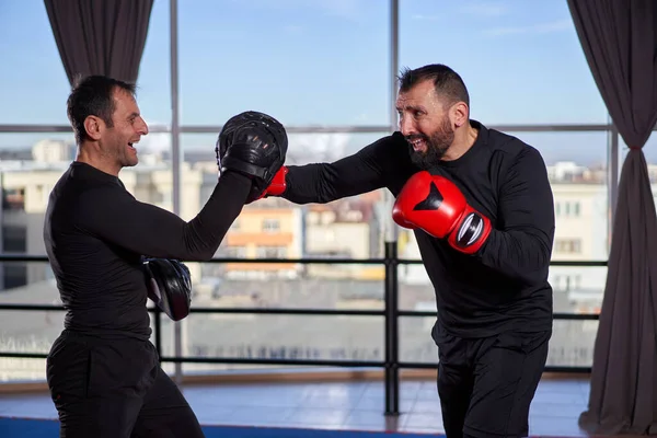 Boxer Frapper Mitaines Avec Son Entraîneur Dans Salle Gym Images De Stock Libres De Droits