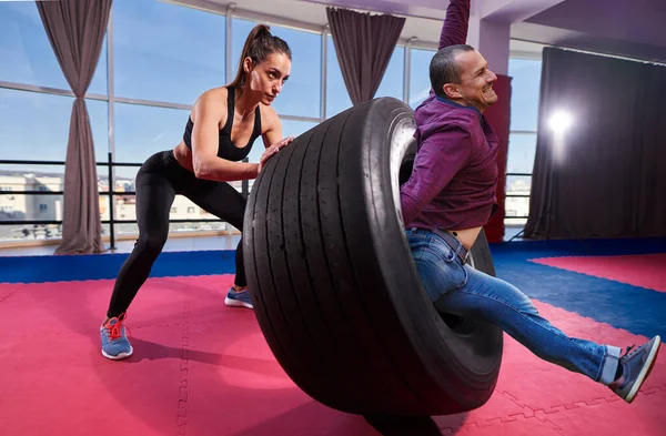 Funny Image Man Coming Out Tire Flipped Strong Woman — Stock Photo, Image