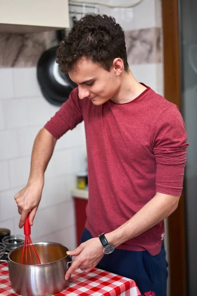 Young Man Stirring Pot Making Dessert — Stock Photo, Image