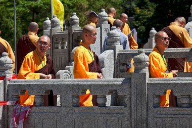 Monks in front of Big Buddha in Lantau Island clipart