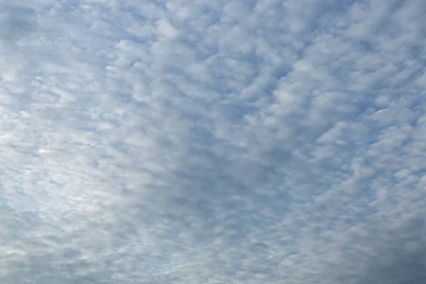 Niebieskie niebo tło z malutkimi chmurami Obraz Stockowy