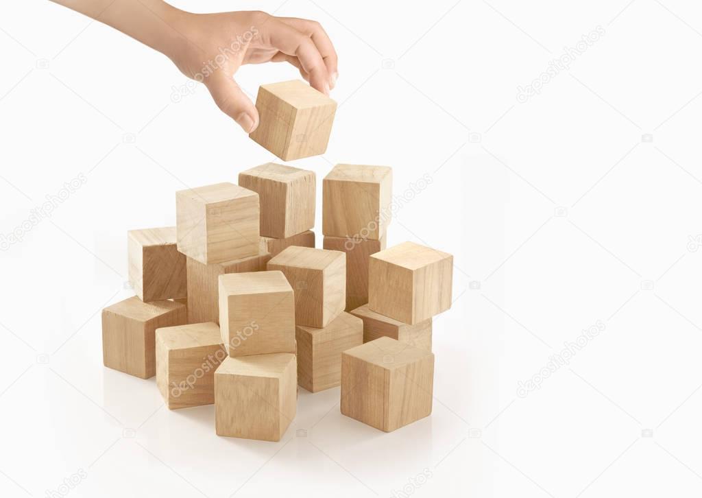 Two hands playing wooden box on isolated background.
