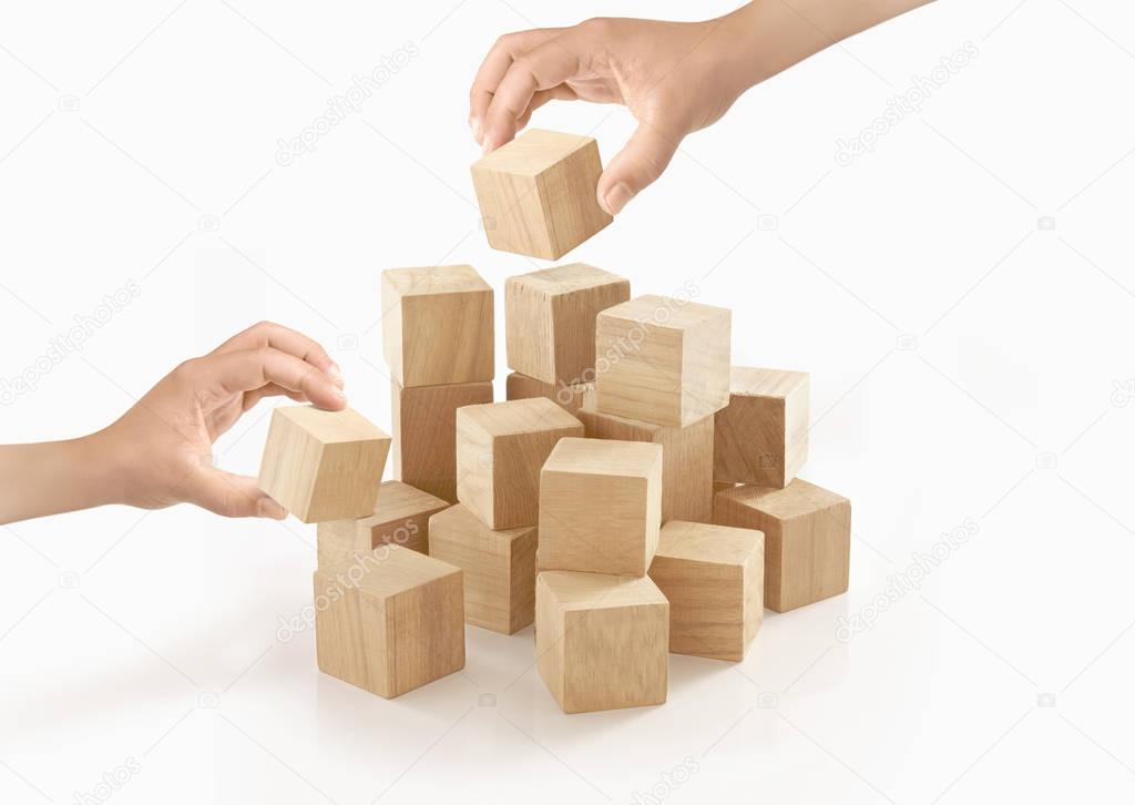 Two hands playing wooden box on isolated background.