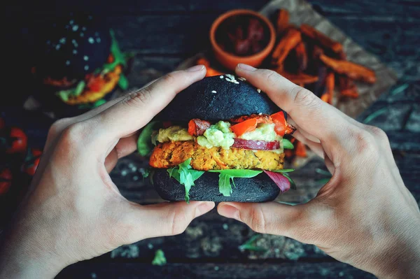 Manos Sosteniendo Garbanzo Fresco Hamburguesa Vegana Negra Con Batata Espinacas — Foto de Stock