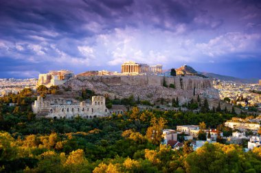 View of Parthenon Temple and Odeon of Herodes Atticus on Acropolis Hill at sunset, Athens, Greece clipart