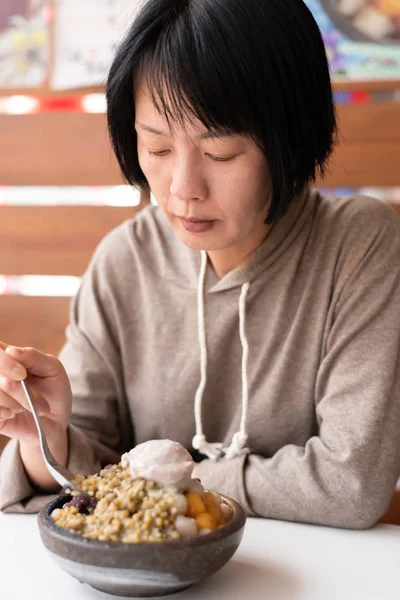 Aziatische vrouw eet geschoren ijs — Stockfoto