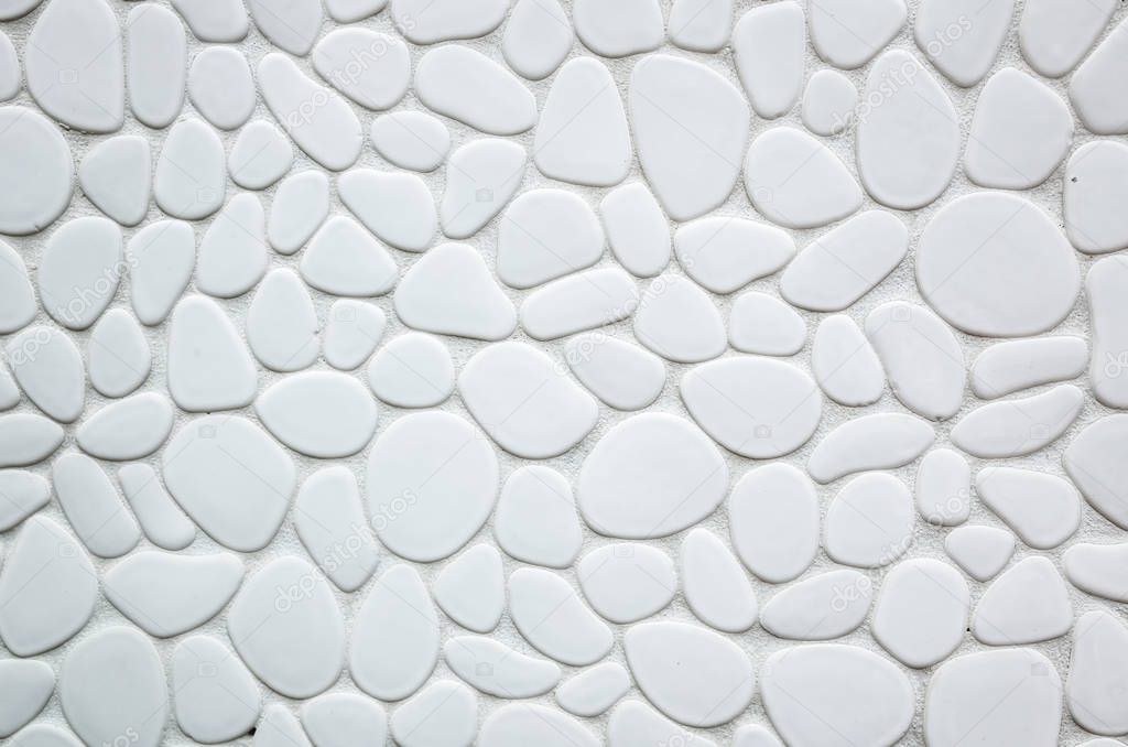 wall of oval and round stone on white background