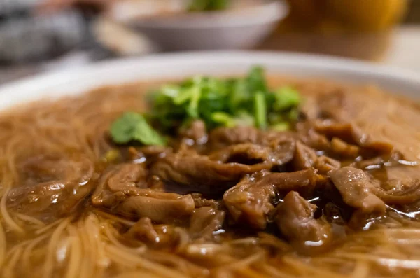 eating Taiwan snack of thin noodles with pork intestine