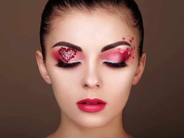 Face of beautiful woman with holiday makeup heart — Stock Photo, Image