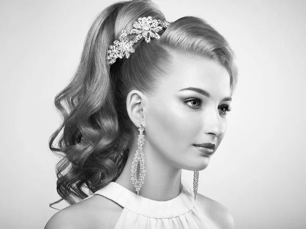 Fashion portrait of young beautiful woman with elegant hairstyle