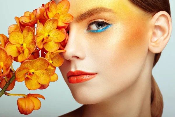 Retrato de hermosa joven con orquídea — Foto de Stock