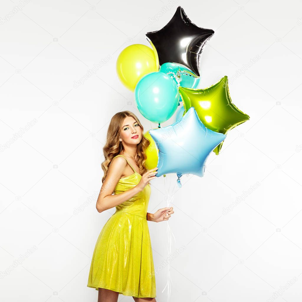 Beautiful young woman with colorful balloons 