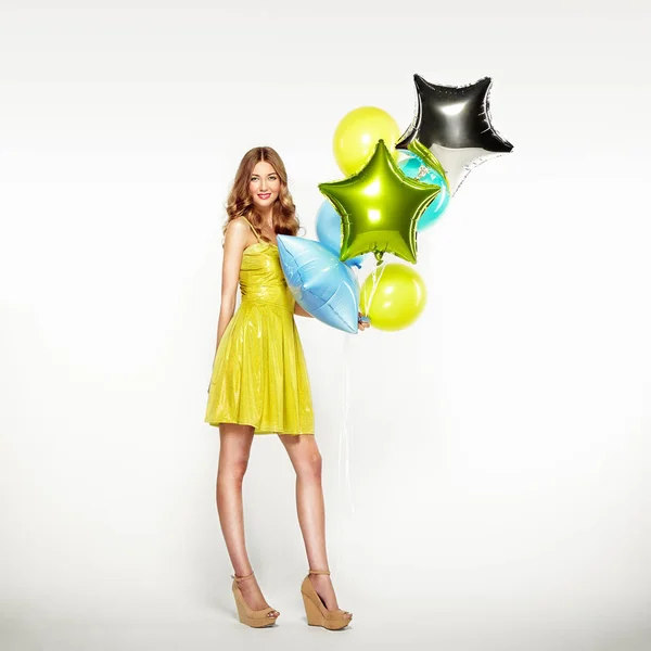 Beautiful young woman with colorful balloons — Stock Photo, Image