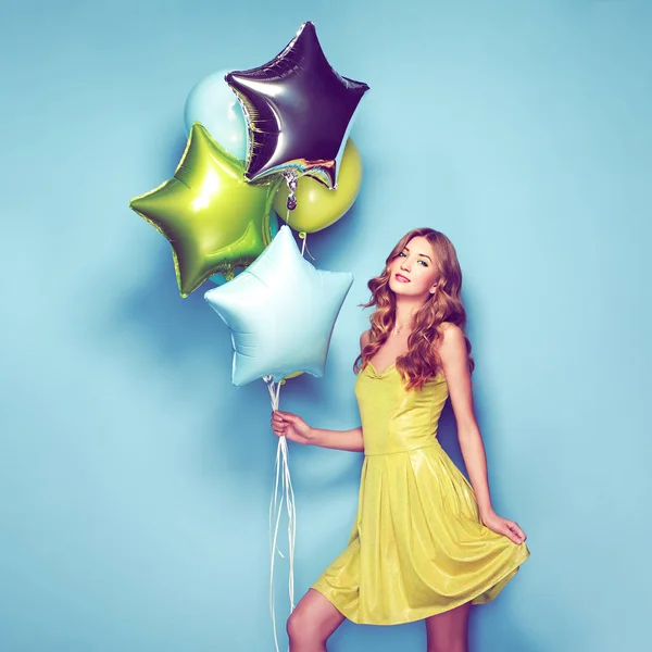 Beautiful young woman with colorful balloons — Stock Photo, Image