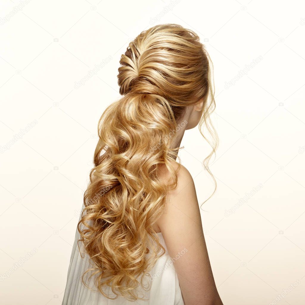 Blonde girl with long and shiny curly hair