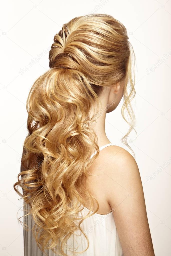 Blonde girl with long and shiny curly hair