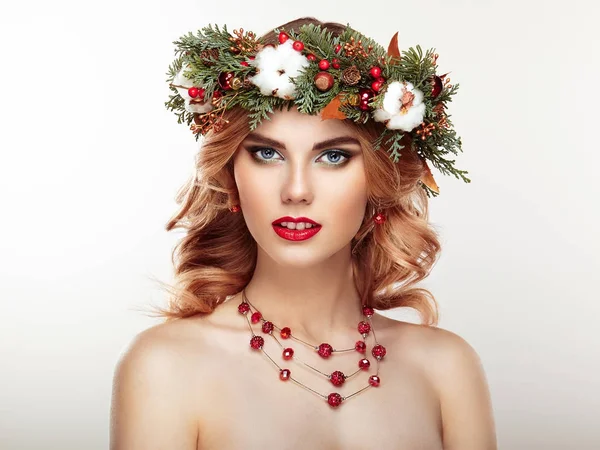 Portrait of beautiful young woman with Christmas wreath — Stock Photo, Image