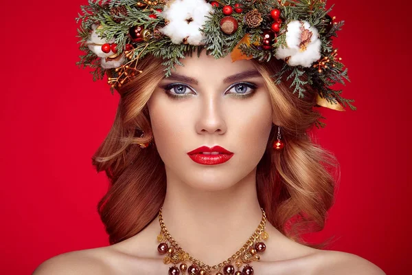 Portrait of beautiful young woman with Christmas wreath — Stock Photo, Image