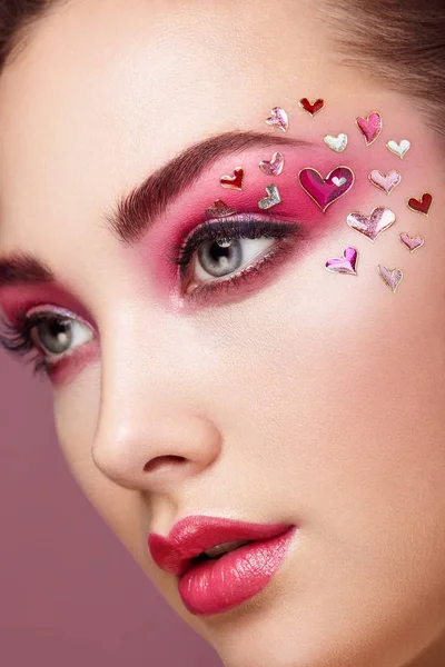 Face of beautiful woman with holiday makeup heart — Stock Photo, Image