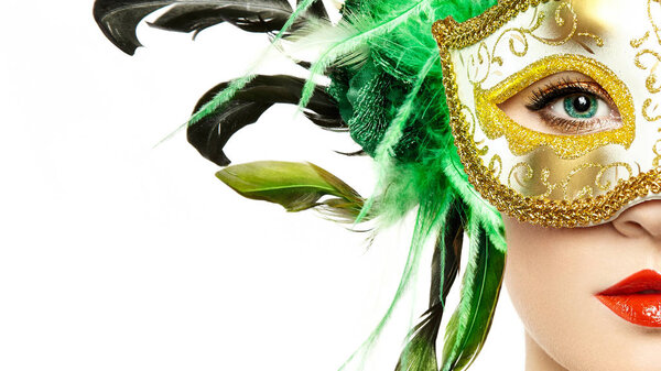 Beautiful young woman in mysterious golden Venetian mask