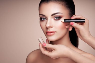 Makeup artist applies skintone clipart