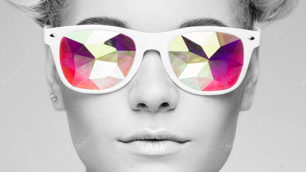 Portrait of beautiful young woman with colored glasses