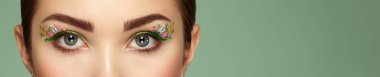 Female eye with flower makeup eyes. Spring makeup. Beauty fashion. Eyelashes. Cosmetic Eyeshadow. Make-up detail. Close up, Macro clipart