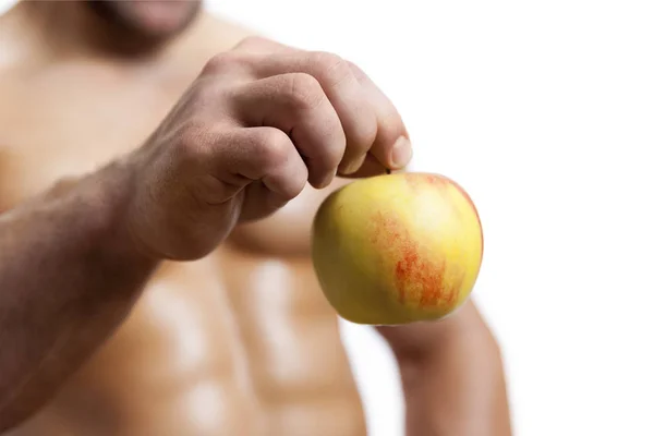 Een appel met een mannenhand — Stockfoto