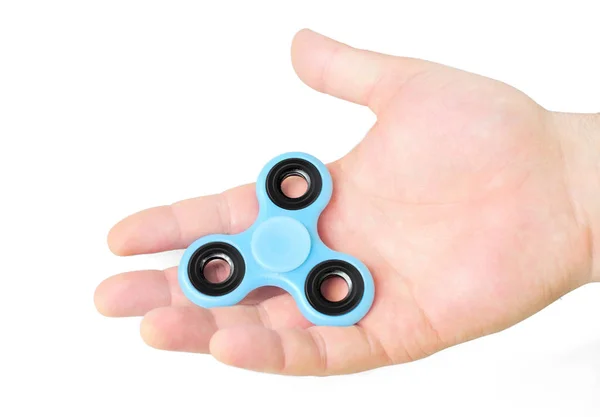 Male hand holding fidget spinner in palm, isolated on white — Stock Photo, Image
