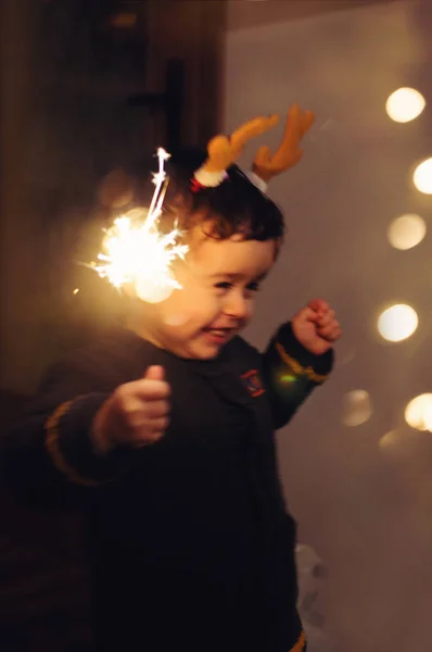 Little kid holding sparkle stick, dancing with joy — Stock Photo, Image