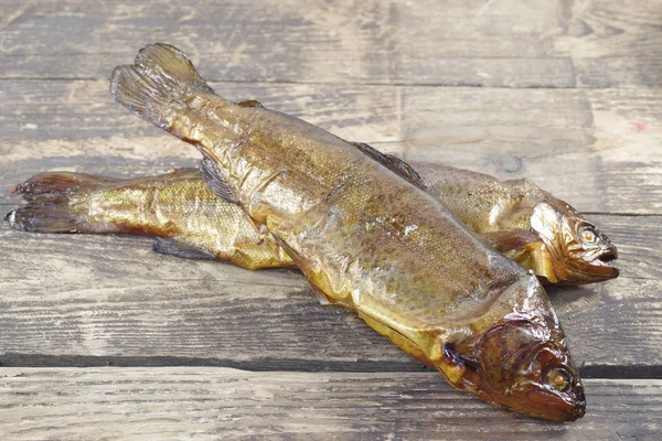 Smoked trout on wooden background — Stock Photo, Image