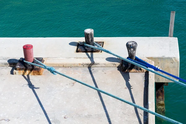 Blue Ropes on Red and Black Bollards — Stock Photo, Image