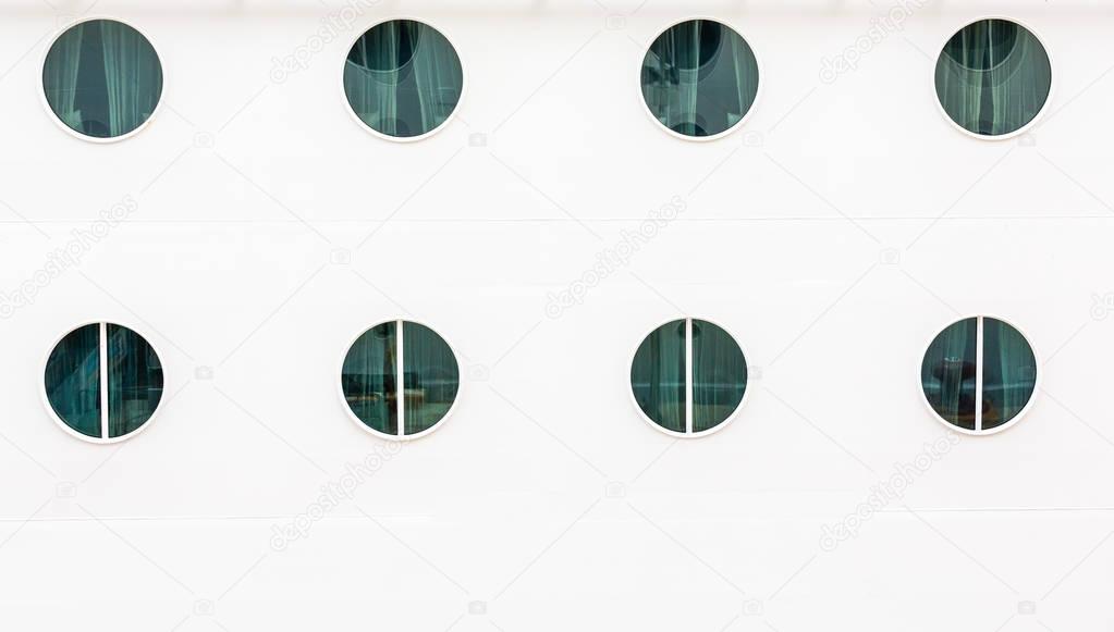 Eight Portholes on White Bulkhead