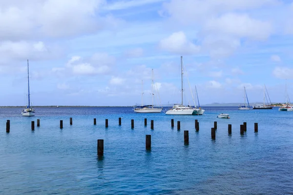 Sailboats Beyond Pilings in Bonaire — Stock Photo, Image