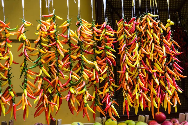 Strands of Colorful Peppers in a Market — Stock Photo, Image