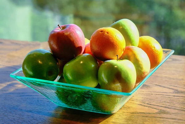 Manzanas y naranjas en la ventana — Foto de Stock