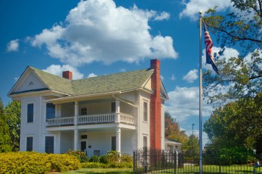 White Two Story Farm House with Flagpole