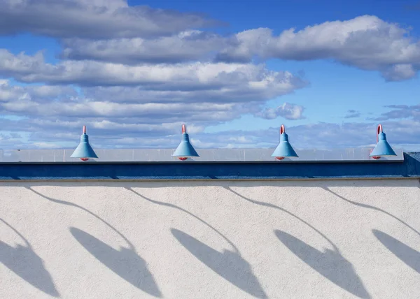 Shadows of Old Blue Lamps on White Stucco — 스톡 사진