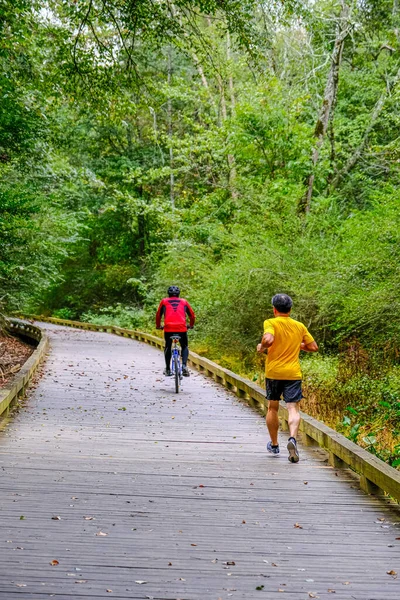 Runner and Cyclest on Trail — Stock Photo, Image