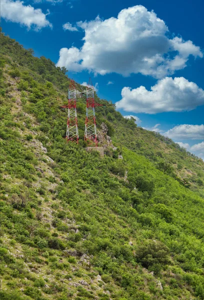 Red and White Towers on Green Hill — Stock Photo, Image