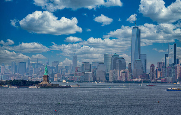 Statue of Liberty in New York Harbor with Manhattan skyline and Freedom Tower in background