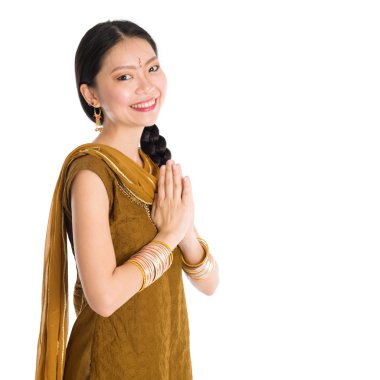 Woman in Punjabi clothes greeting.